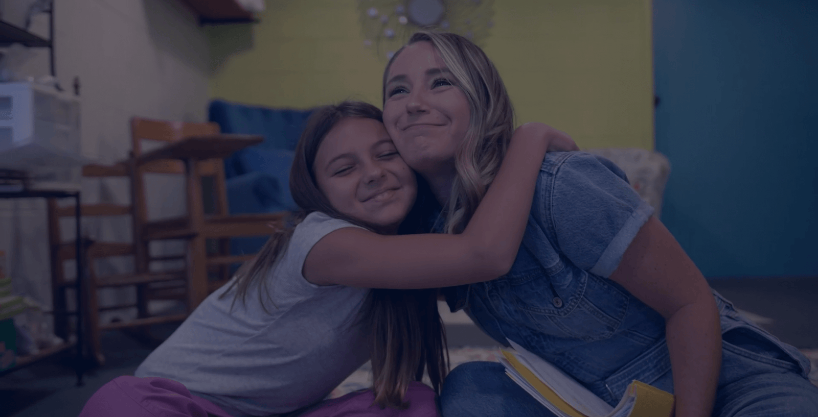 student and teach hugging and smiling